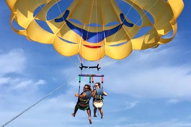 Tandem parasail gliding high above the Gulf of Mexico while parasailing on St. Pete Beach Florida